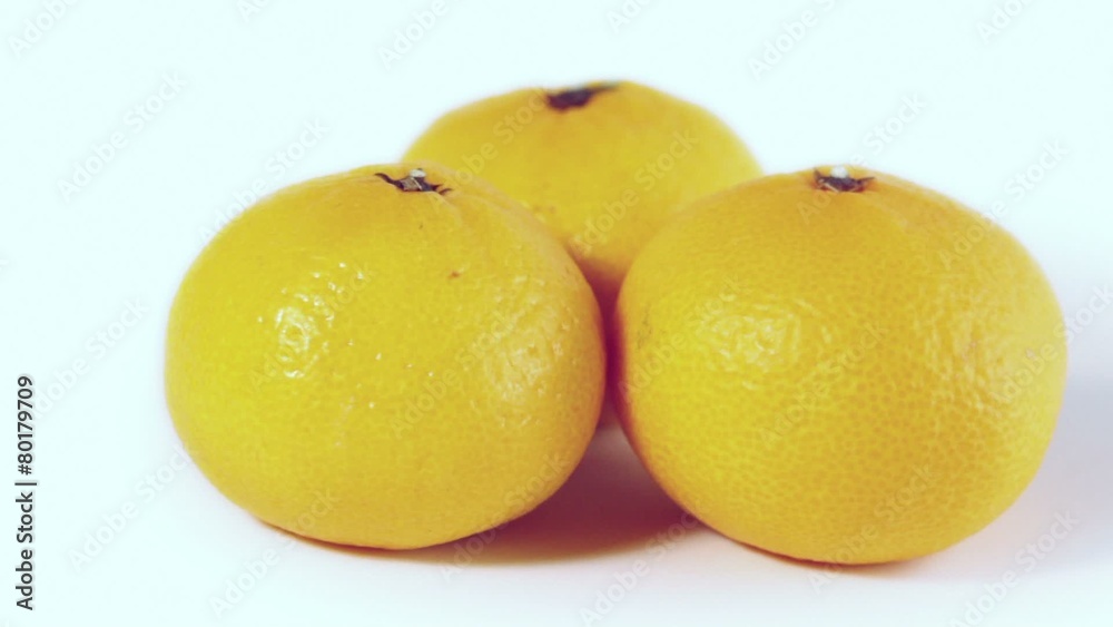 Three oranges spins isolated at white background closeup Three oranges spins isolated at white background closeup