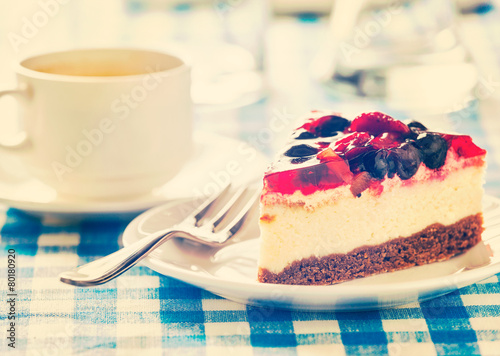 Cake on plate with fork and coffee cup photo