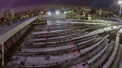 Electric train car rides from depot with many railway tracks photo