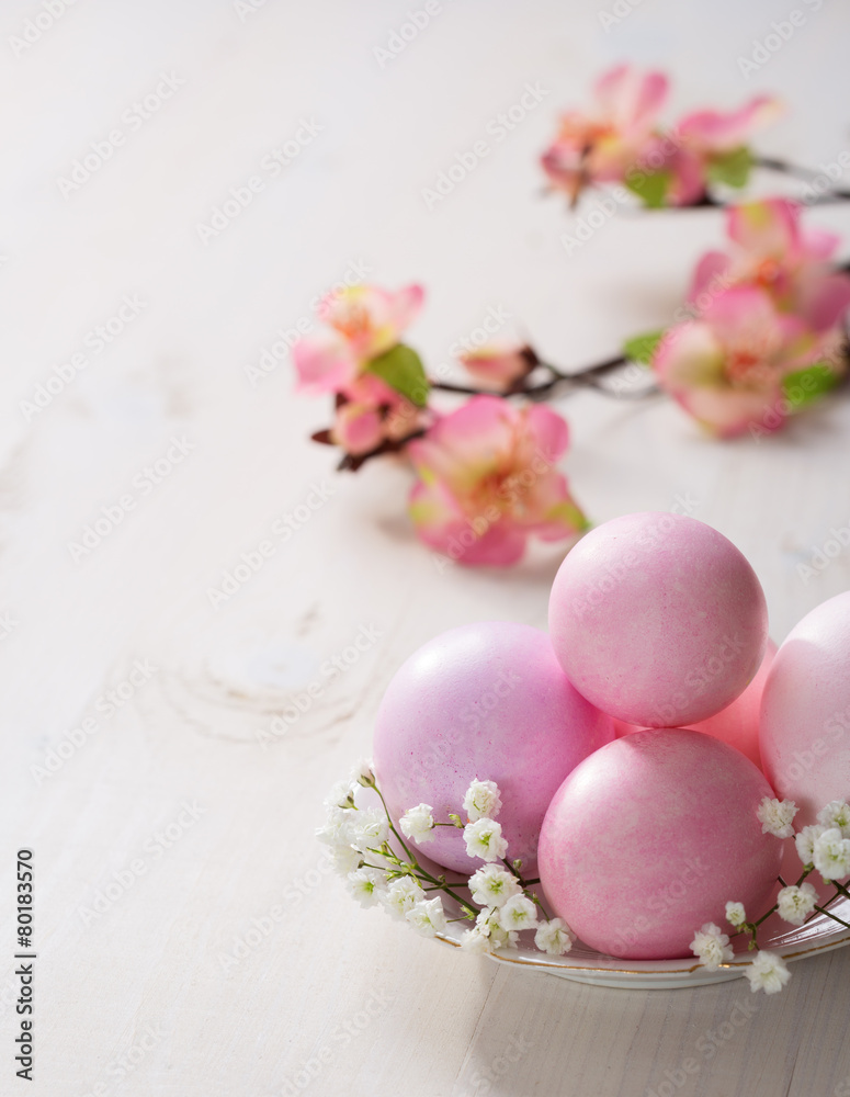 Plate with pink Easter eggs on wooden table. Plate with pink Easter eggs on wooden table.