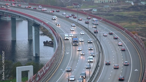 Cityscape with river and car traffic on the bridge photo