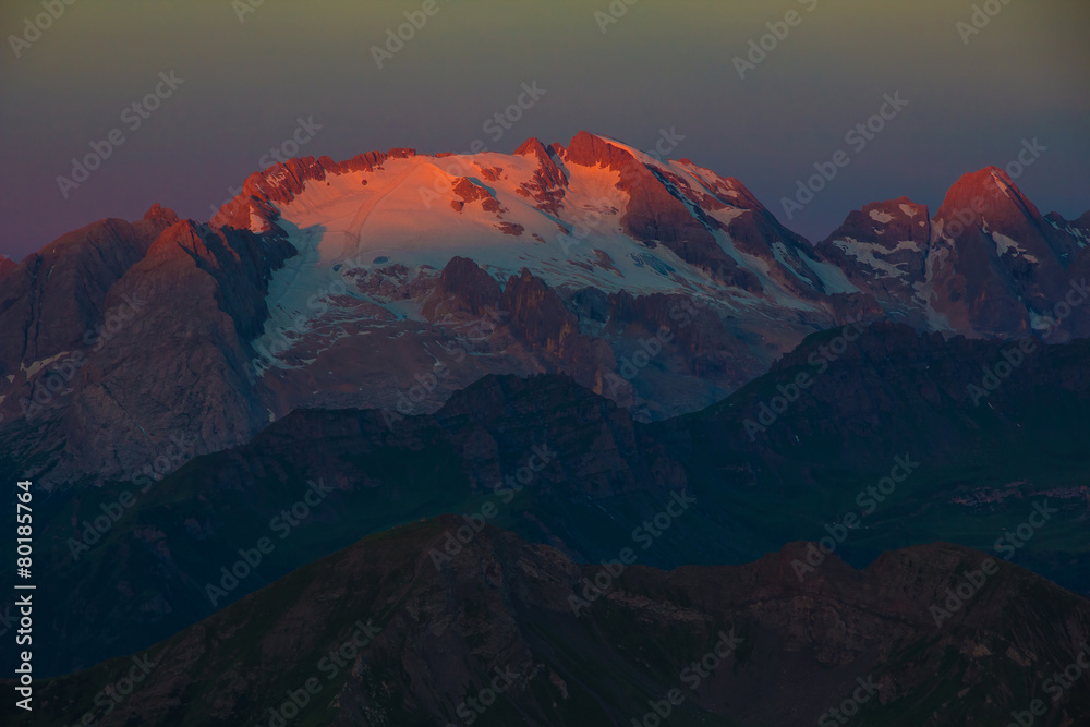 Sunrise in Dolomites - first sunrays on Marmolada mountain