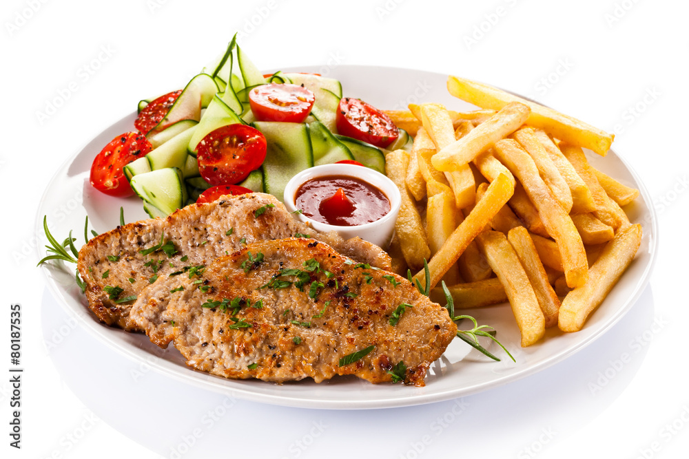 Pork chops, French fries and vegetables