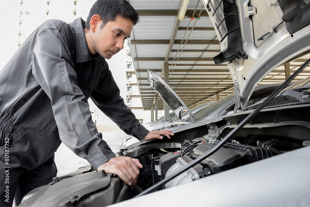 Auto mechanic checking car engine Auto mechanic checking car engine