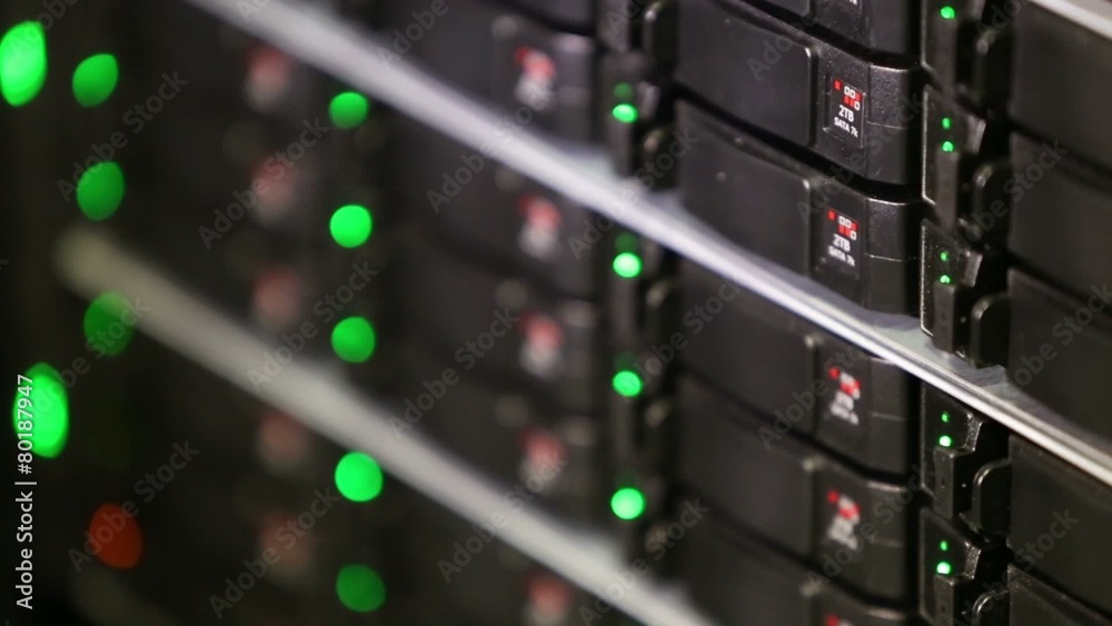 Rack of data server with many hard drives and LED lamps blinks