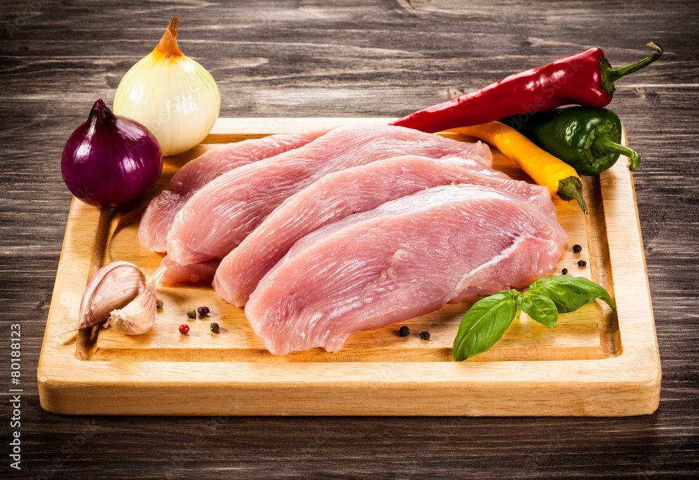 Raw chicken breasts on cutting board Raw chicken breasts on cutting board