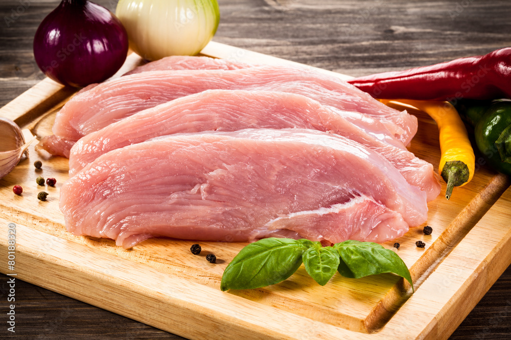 Raw chicken breasts on cutting board Raw chicken breasts on cutting board