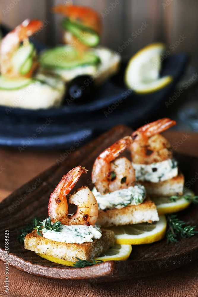 Appetizer canape with shrimp and lemon Appetizer canape with shrimp and lemon