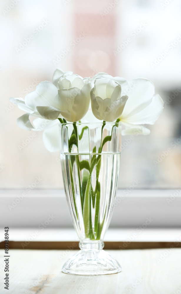 Beautiful tulips in vase on windowsill Beautiful tulips in vase on windowsill