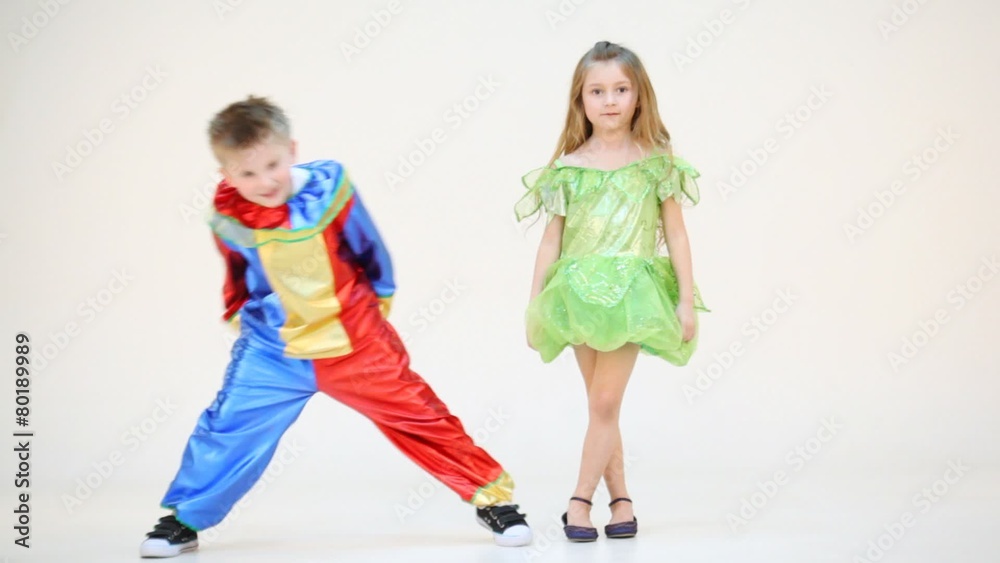 Two children in costumes bowing isolated on white Two children in costumes bowing isolated on white