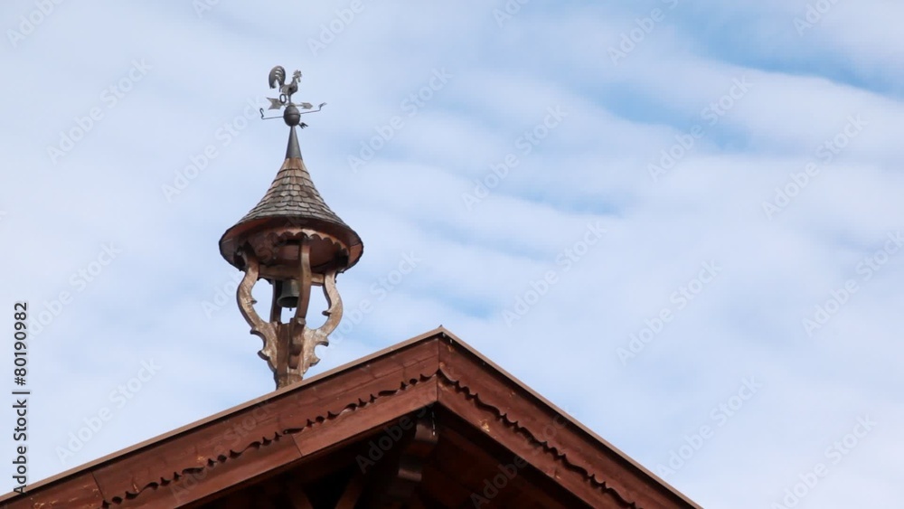 House roof is decorated by ahand bell and compass with cock House roof is decorated by ahand bell and compass with cock