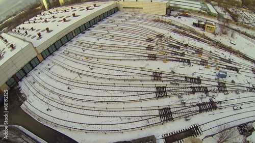 Car shed with many railway tracks covered by snow photo