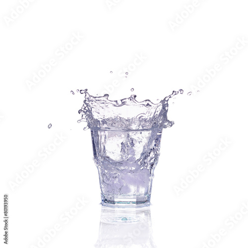 Fresh water splash in a glass isolated on white background