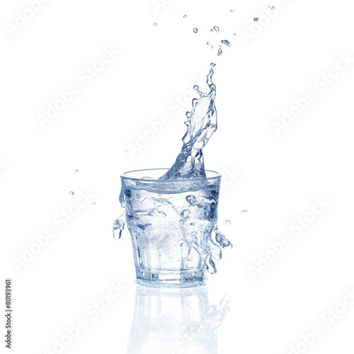 Fresh water splash in a glass isolated on white background