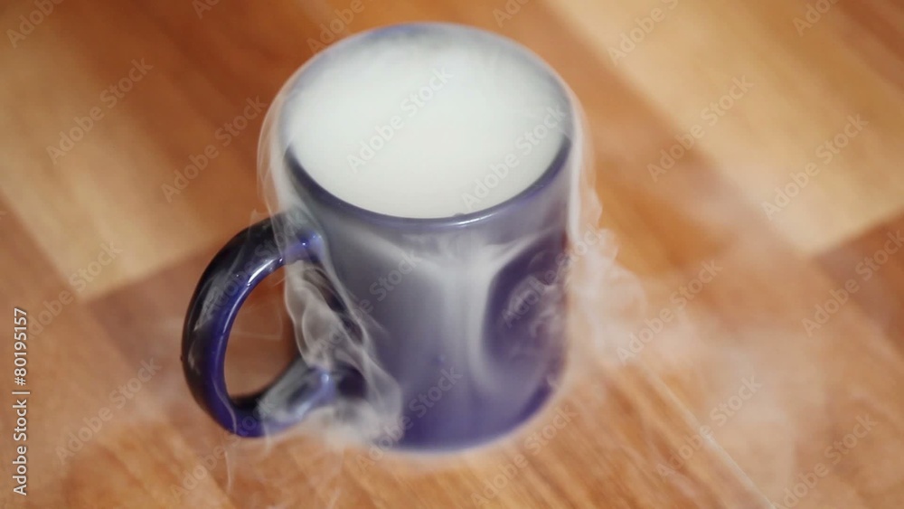 The dense steam from the evaporation of dry ice in the blue mug