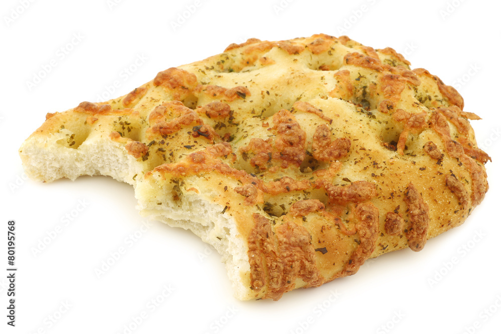 freshly baked focaccia bread with a bite missing on a white back freshly baked focaccia bread with a bite missing on a white back