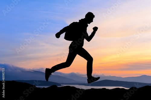 Running jumping man sunset and mountain. Sport sky sun