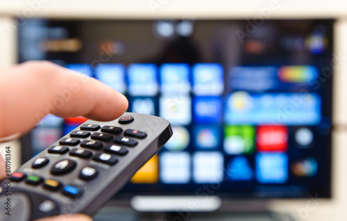 Smart tv and hand pressing remote control