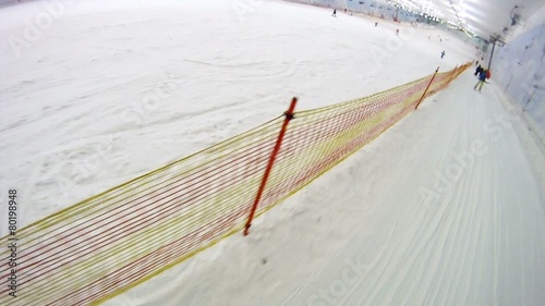 Skilift goes near boy going on skis in skiing center photo