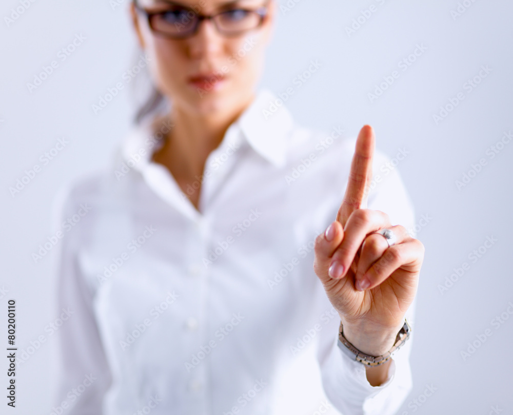 Woman touching an imaginary screen with her finger Woman touching an imaginary screen with her finger