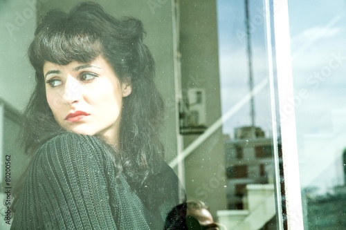 Melancholic Girl at the Window. photo