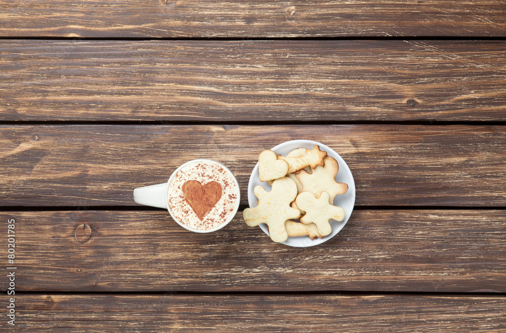 Cup of cappuccino with heart shape and cookies Cup of cappuccino with heart shape and cookies