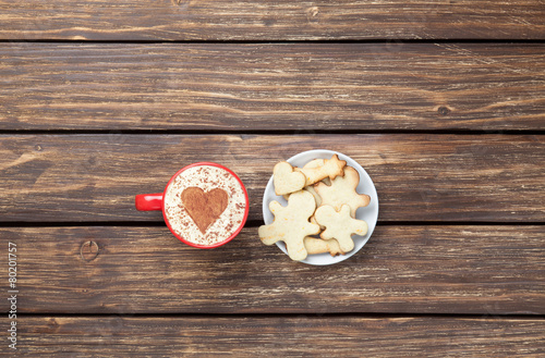 Cup of cappuccino with heart shape and cookies