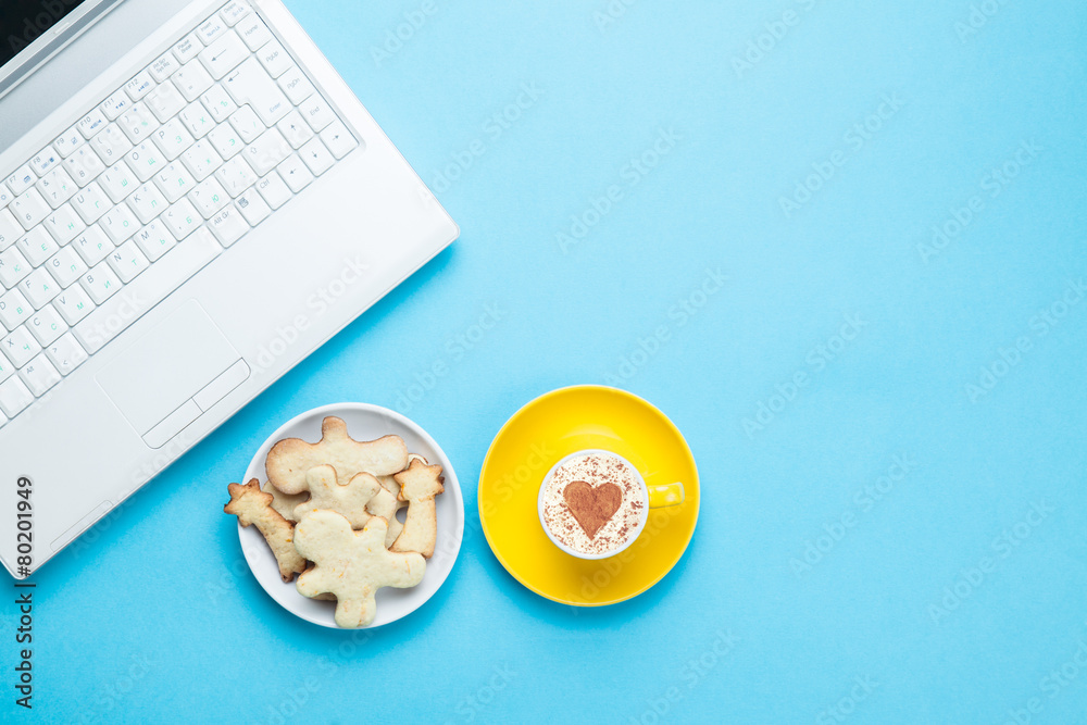 Cup of cappuccino with heart shape and cookies