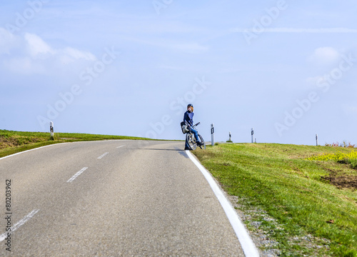 young boy with bike in rural area