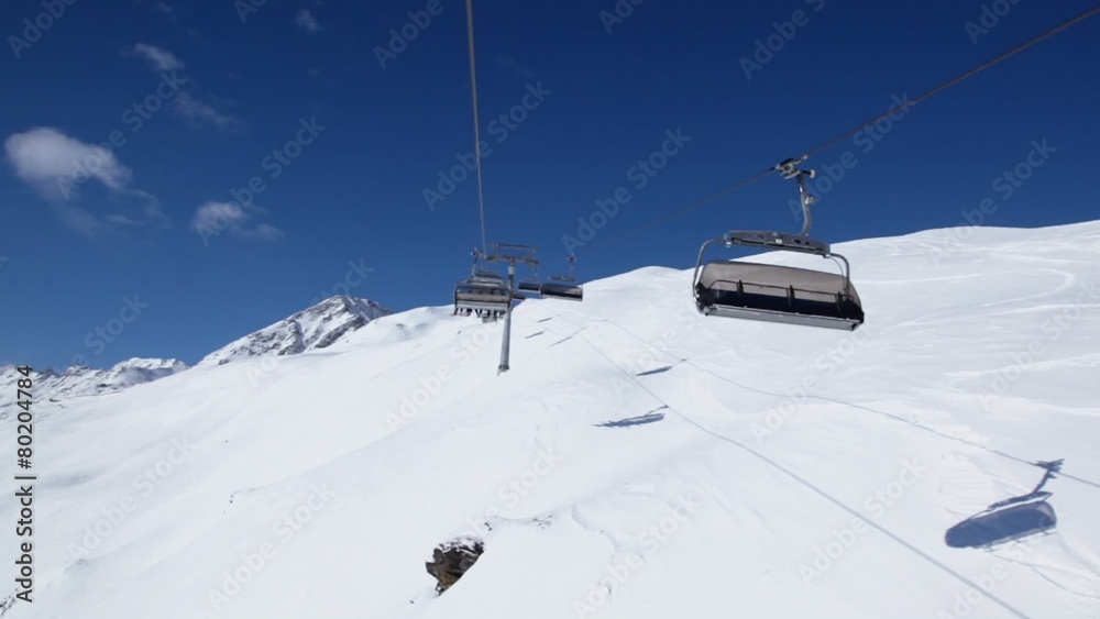 Ropeway cabins ride with skiers in snow-capped mountains Ropeway cabins ride with skiers in snow-capped mountains
