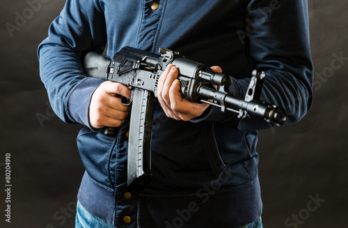terrorist holding kalashnikov rifle photo