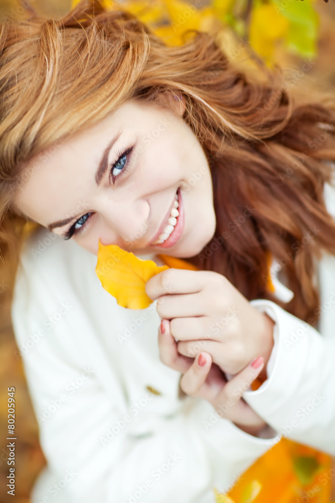 Beautiful woman in a yellow sweater in autumn park Beautiful woman in a yellow sweater in autumn park