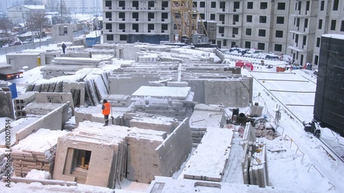 Worker supervising the move of block panels. Timelapse photo