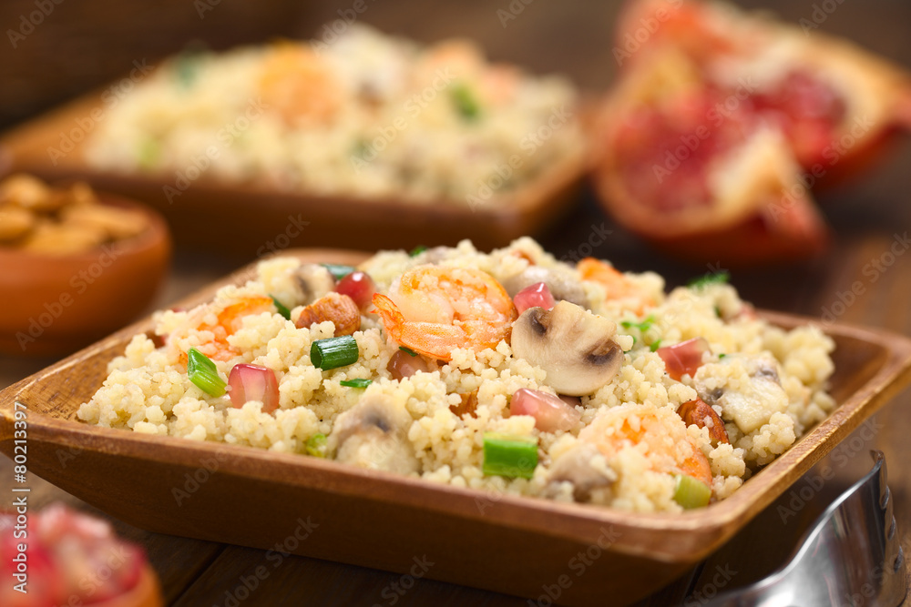 Couscous dish with shrimps, mushroom, almond, pomegranate Couscous dish with shrimps, mushroom, almond, pomegranate