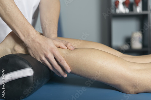 Beautiful young woman relaxing with hand massage at beauty spa