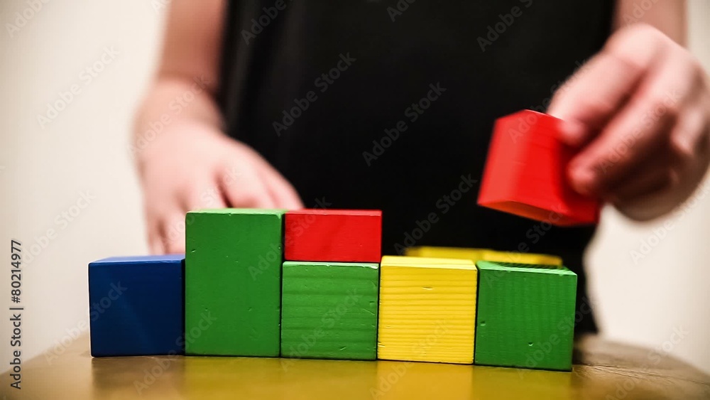 teenager boy builds a tower of bricks blocks play a major hand teenager boy builds a tower of bricks blocks play a major hand
