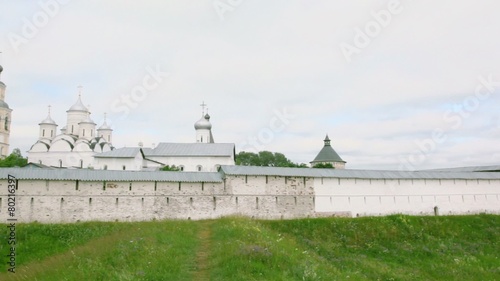 Many buildings beyond wall of Saviour Prilutskyl Monastery in Vologda, Russia photo