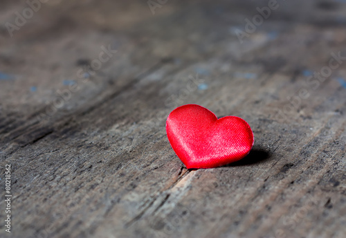 Red heart on a wooden surface