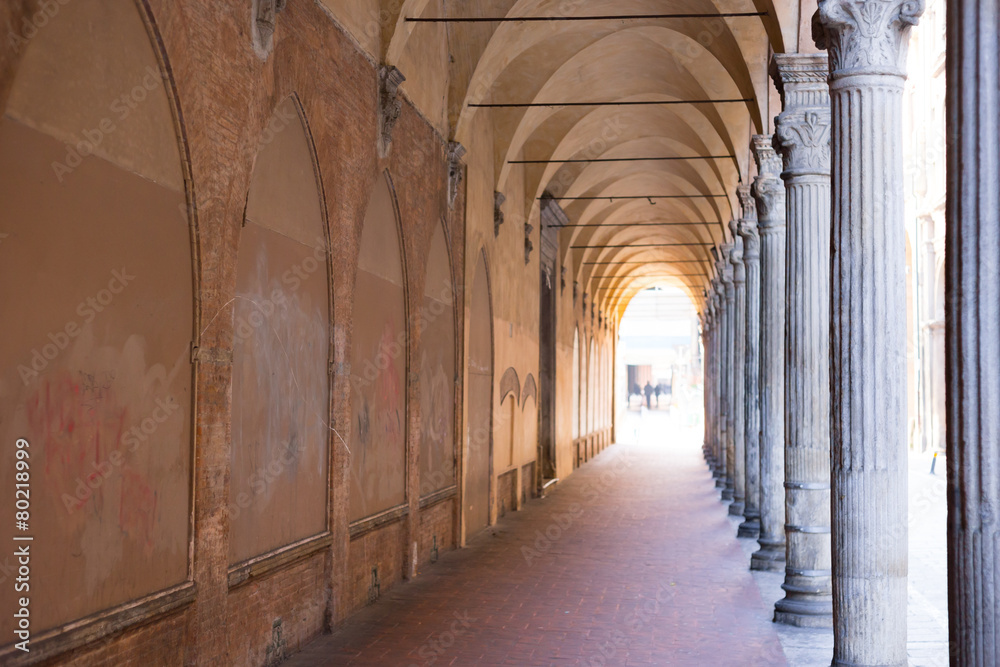 italian sidewalk with ancient columns and old brick walls