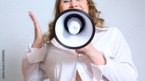 Pregnant woman shouting on megaphone and making gestures photo