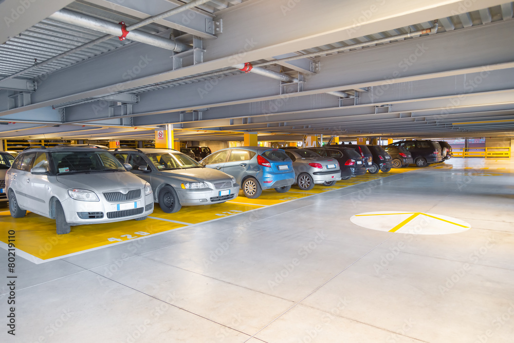 Parking garage, interior with a parked cars Parking garage, interior with a parked cars