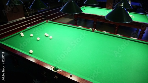 Player pockets billiard ball after precise hit by cue photo