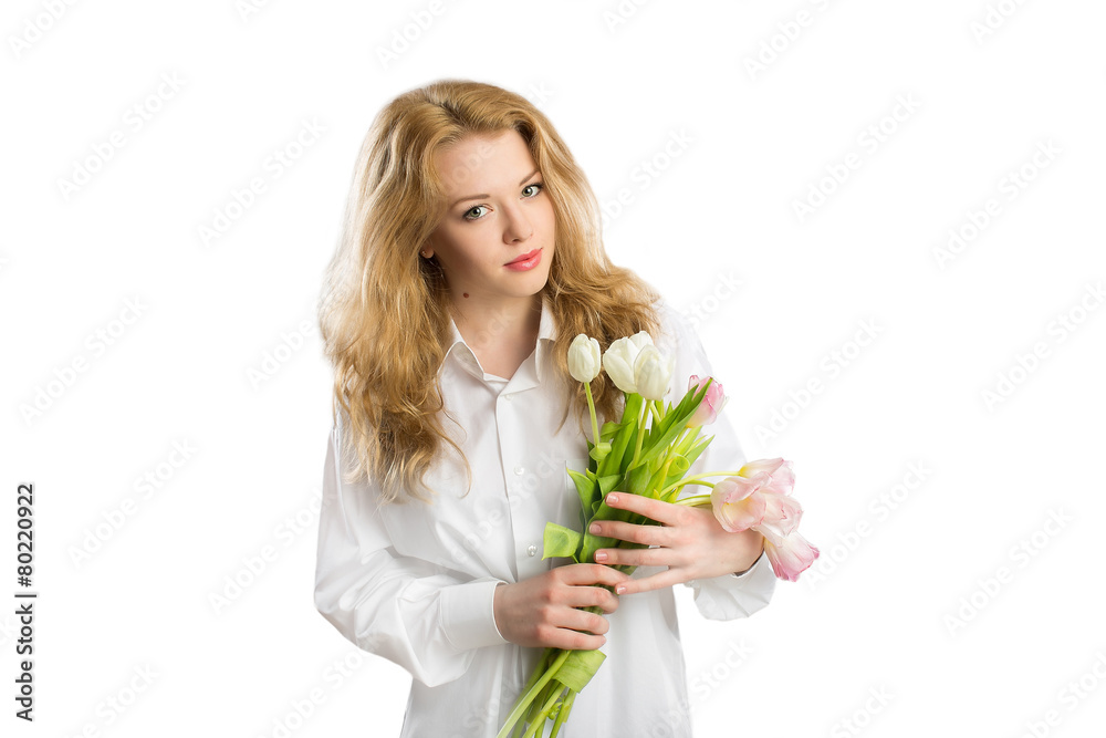 Young girl with flowers looking at the camera on a white backgro Young girl with flowers looking at the camera on a white backgro