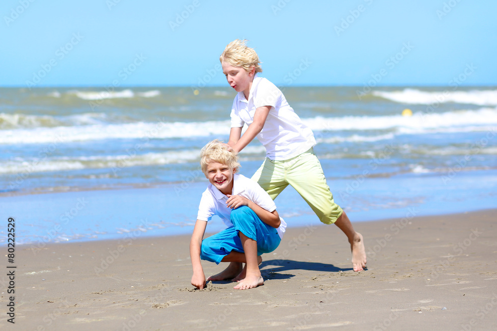 Two brothers enjoying summer vacation on the beach Two brothers enjoying summer vacation on the beach