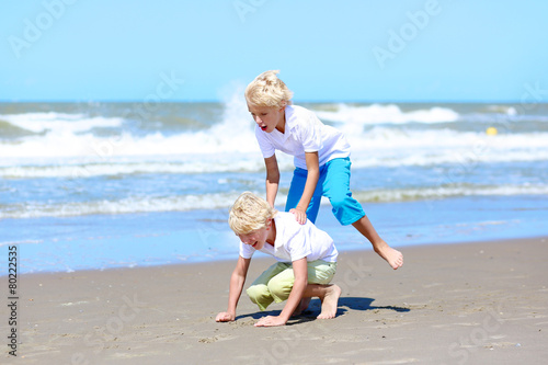 Two brothers enjoying summer vacation on the beach