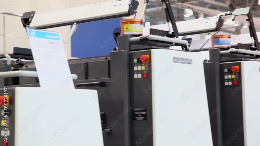 Row of printing equipment with cans of paint on it Row of printing equipment with cans of paint on it