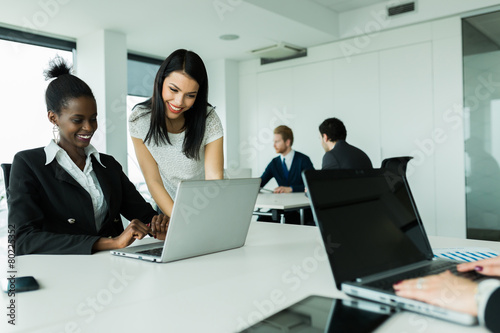Women working on laptops in an office