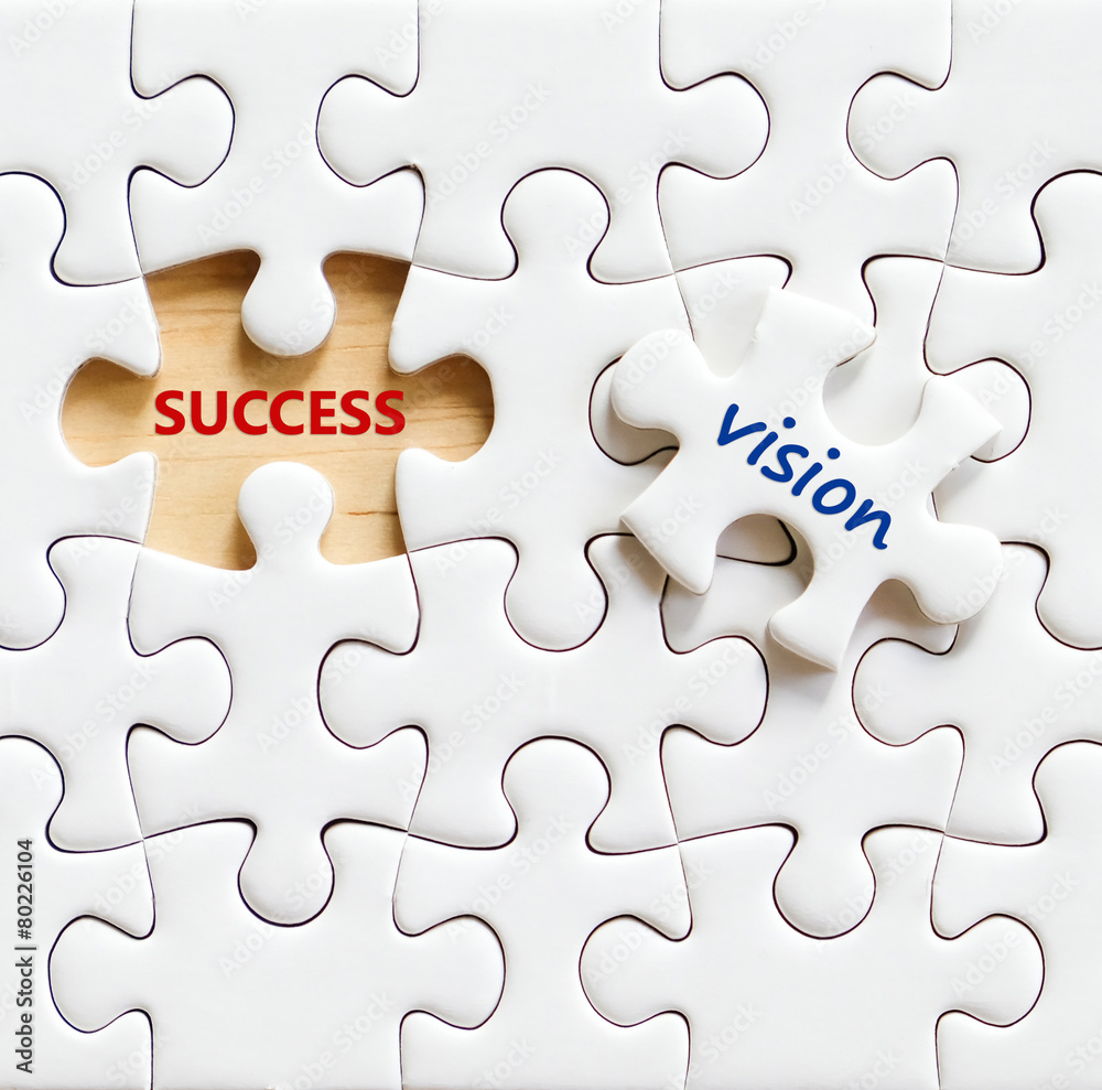 Success and vision words on jigsaw puzzle background Success and vision words on jigsaw puzzle background