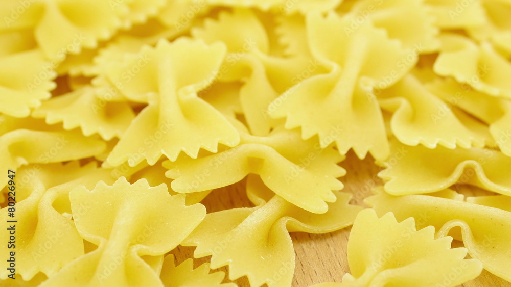 Farfalle - bow shaped pasta background in 4K UHD Farfalle - bow shaped pasta background in 4K UHD