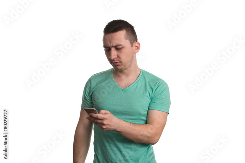 Young Man Text Messaging At His Smart Phone